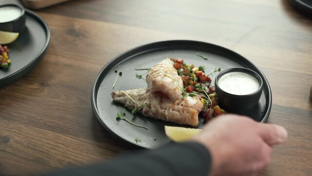 Grilled fish fillet with vegetables served on wooden table. Healthy food concept. top view.