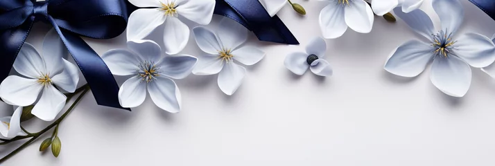 Fotobehang Flowers and silk navy ribbon on white panoramic background. Flat lay top view composition with copy space for banner card wedding © SappiStudio