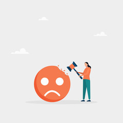 Concept of overcoming stress and negative influence. Stress resistance, victory over depression. The girl hits a sledgehammer with a negative emoticon.
