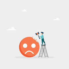 Concept of overcoming stress and negative influence. Stress resistance, victory over depression. The guy hits a sledgehammer with a negative emoticon.
