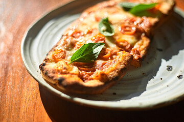 Sliced and served Italian pizza Margherita with basil leaves