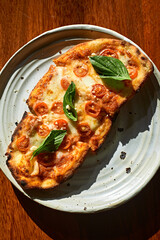 Sliced and served Italian pizza Margherita with basil leaves