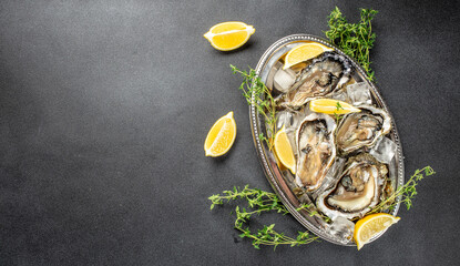 Oysters plate with lemon. Restaurant menu, dieting, cookbook recipe top view