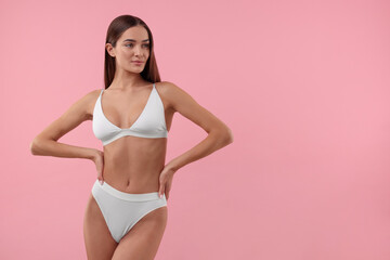 Naklejka premium Young woman in stylish white bikini on pink background. Space for text