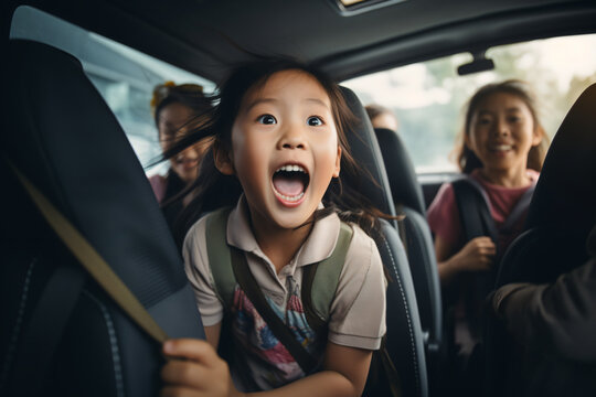 A Little Girl Is Sitting In The Back Seat Of A Car