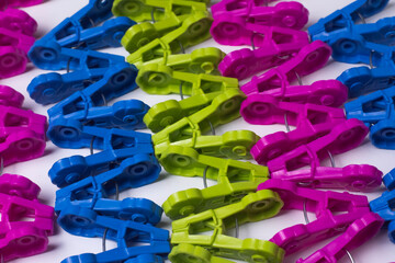 Plastic clothes pegs, assorted colors, bright and colorful, placed all over the area. For various uses