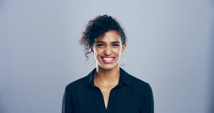 Face, smile and fashion with a young woman in studio on a gray background for style positivity. Portrait, happy and trendy with a person from Morocco in a good mood or carefree in a clothes outfit