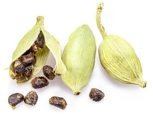 Green cardamom pods and seeds isolated on white background.