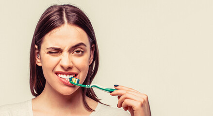 Portrait of a smiling cute woman holding toothbrush. Smiling woman with healthy beautiful teeth...