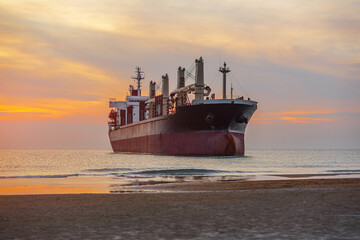 a large cargo ship, a tanker stuck aground off the coast of the sea.