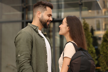 Long-distance relationship. Beautiful young couple with backpack outdoors