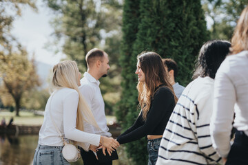 University students discussing and exchanging knowledge in the park. Working on a faculty project, preparing for exams, and studying subjects together. Successful academics through teamwork.