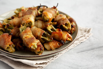 Homemade Bacon-Wrapped Jalapeno Poppers on a Plate, low angle view. Close-up.