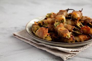 Homemade Bacon-Wrapped Jalapeno Poppers on a Plate, low angle view. Copy space.