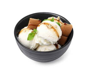Tasty ice cream with caramel sauce, mint, candies and nuts in bowl isolated on white