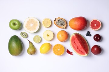 Different ripe fruits and berries on white background, top view