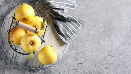 organic yellow apples in a basket on the table