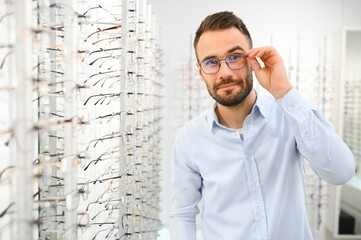 man chooses glasses for vision correction in an ophthalmology salon. Glasses for vision correction