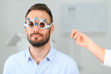 man checking up vision with special ophthalmic glasses