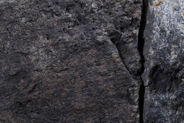 Gray stone texture, dark abstract background. Natural mineral rock close up details, empty backdrop...