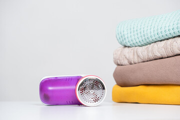 Anti-pilling razor for removing pills from clothes, a place for text. Clothing care device