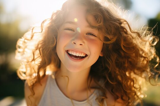 Close-up capturing the joyful expression of a girl in a sunlit park. The image resonates with happiness, youthfulness, and the vibrant ambiance of the sunny surroundings.