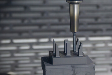 The CNC milling machine cutting the graphite electrode parts.
