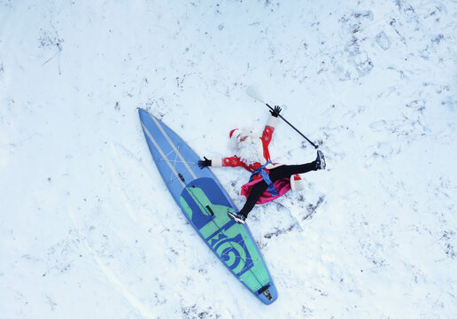 Funny Santa with a paddle in his hand