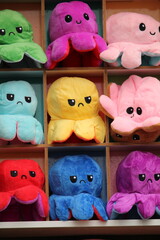 Colorful reversible octopus plushies with different emotions.