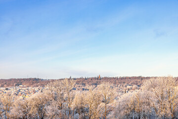 Beautiful frosty landscape view at a city by a hill