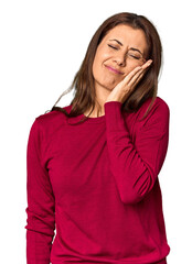 Elegant middle-aged Caucasian woman in studio setting having a strong teeth pain, molar ache.