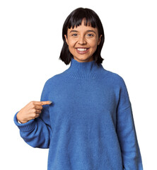 Young Hispanic woman with short black hair in studio person pointing by hand to a shirt copy space, proud and confident