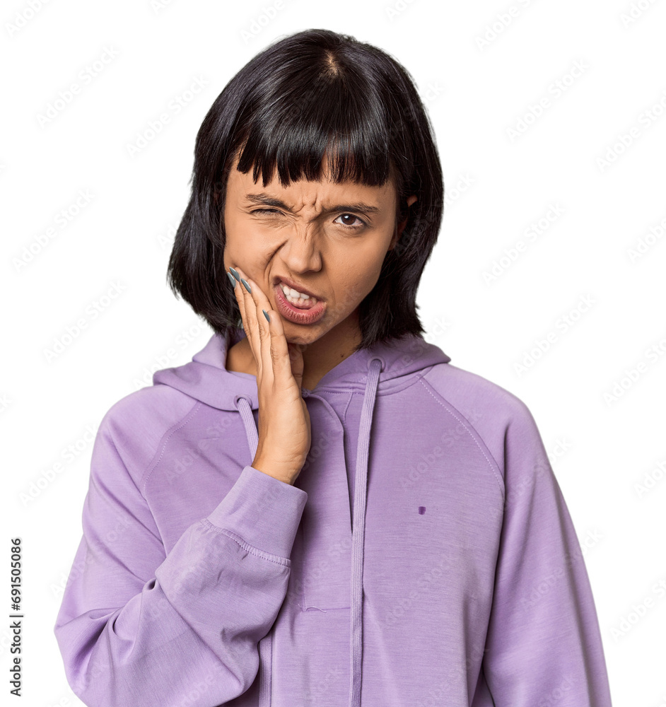 Wall mural Young Hispanic woman with short black hair in studio having a strong teeth pain, molar ache.