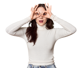 Young Caucasian woman in a studio setting showing okay sign over eyes