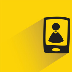 user in mobile phone with shadow on yellow background