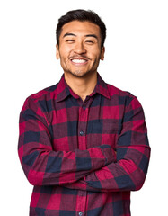Young Chinese man in studio background who feels confident, crossing arms with determination.
