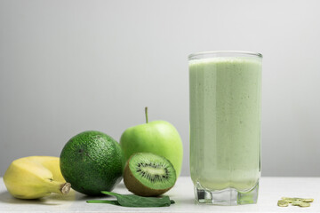 Green detox smoothie, blended vegetarian drink, protein milkshake in a glass from spinach, banana,...