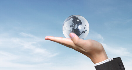 Glass globe in hand,Energy saving concept