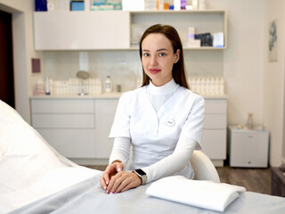 Portrait of friendly female woman beautician, aesthetic nurse or masseuse at her workplace.