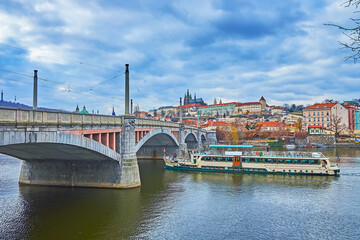 Fototapeta na wymiar The tourist ship on Vltava River at the Manes Bridge, Prague, Czechia