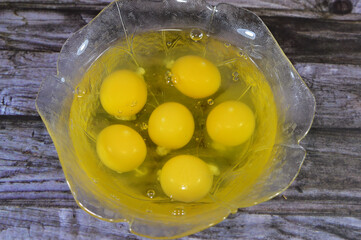 raw uncooked eggs in a bowl ready to be cooked, organic fresh and raw hen chicken white eggs, stack...