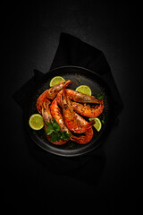 Langoustines, Australian, freshly frozen on ice, top view, lime and greens,