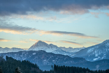 Alpine panorama with snow-covered mountains on a frosty morning at sunrise