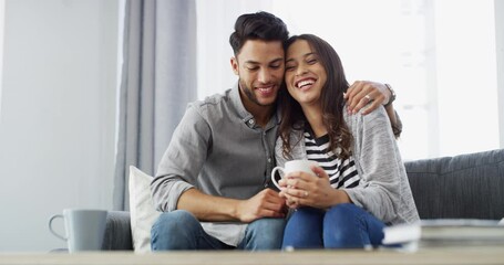 Couple, hug and embrace on sofa with romance, happy and bonding in living room of home with coffee or relax. People, man and woman on couch for smile, love or relationship in lounge of house together