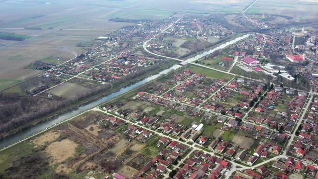 Aerial view of small town Bac in Serbia and canal DTD flowing through