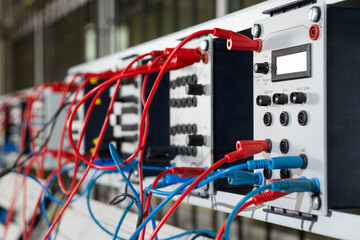 Electronic and magnetic panel with blue and red wires.