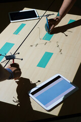 Hands with digital pens using the interactive table