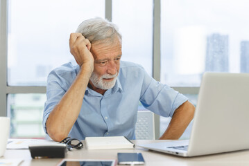 Stressed mature man looking at debt document - obrazy, fototapety, plakaty