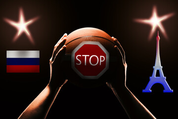Orange basketball in male hands, Russian flag, close up. Concept - The Russian team is prohibited...