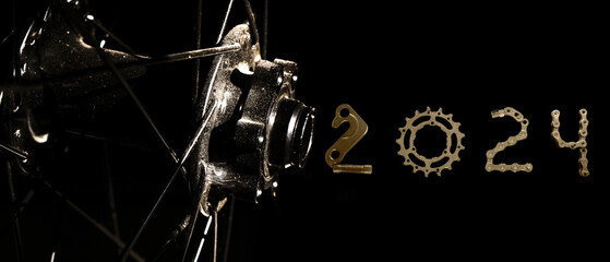 Bike front hub and spoke with 2024 number on black background. 2024 Cycles concept background